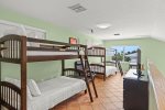Upstairs loft with 2 sets of twin bunk beds, TV, and crafts table. Perfect for kids.